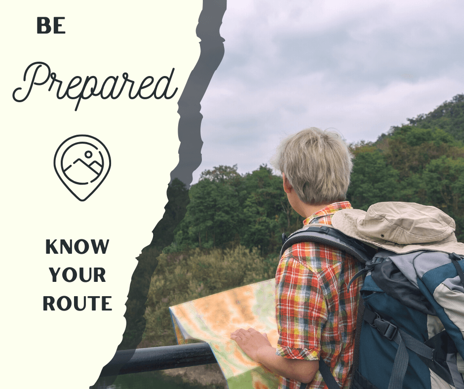 A person with short hair and a backpack examines a map while overlooking a scenic landscape.
