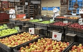 wooden crates with several varieties of red and green apples